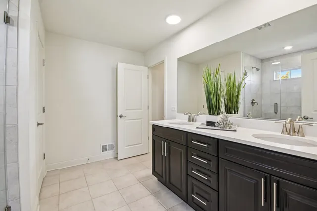 a bathroom with a double vanity sink and a mirror