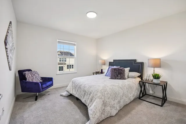 a bedroom with a bed and a couch