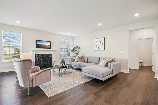 a living room with furniture a fireplace and a table