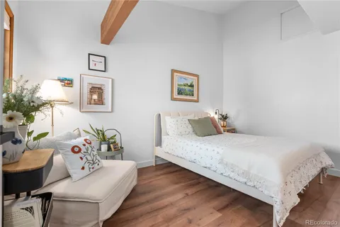 a bedroom with a bed and a couch