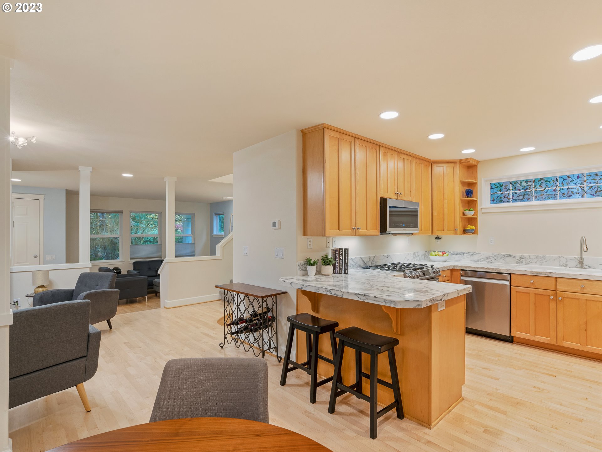 2306 Northwest Miller Road Portland, OR 97229 - Photo 17 of 46 a living room with stainless steel appliances granite countertop furniture a sink a counter top space and a center island