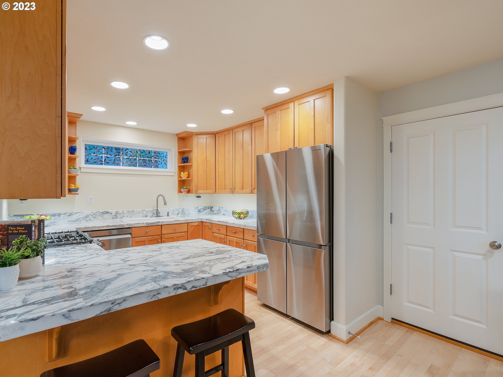 2306 Northwest Miller Road Portland, OR 97229 - Photo 19 of 46 a kitchen with stainless steel appliances granite countertop a refrigerator and a sink
