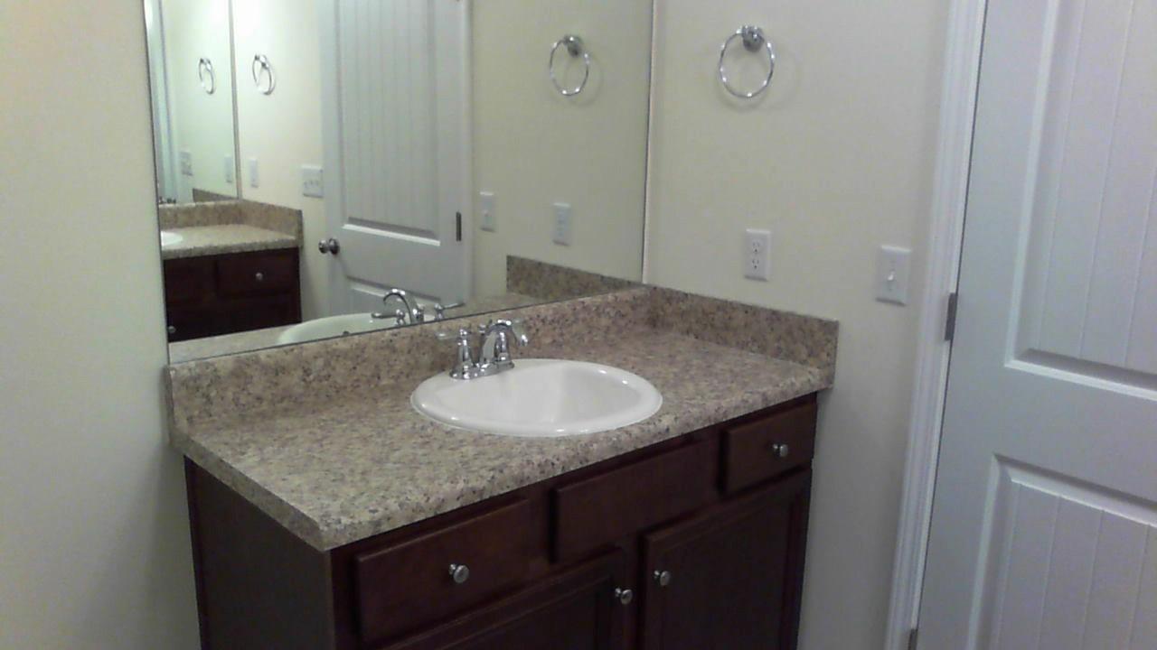 46 Nelly Street Freeport, FL 32439 - Photo 13 of 21 a bathroom with a granite countertop sink and a mirror