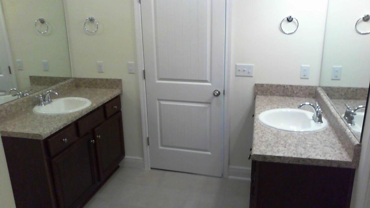 46 Nelly Street Freeport, FL 32439 - Photo 14 of 21 a bathroom with a granite countertop sink and a mirror