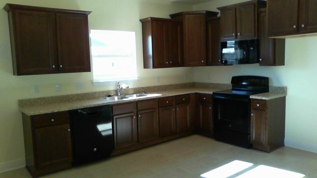 46 Nelly Street Freeport, FL 32439 - Photo 9 of 21 a kitchen with granite countertop a sink and cabinets