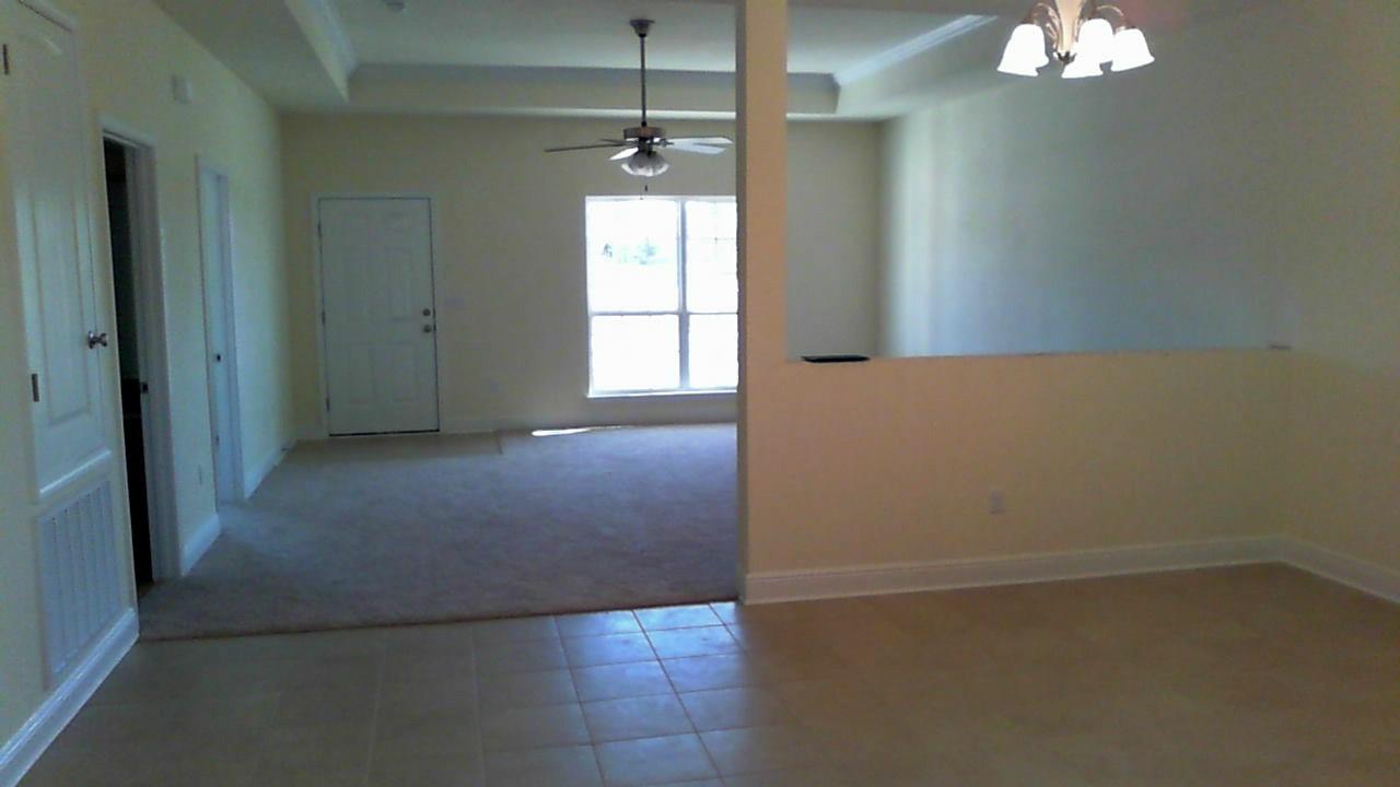46 Nelly Street Freeport, FL 32439 - Photo 10 of 21 an empty room with chandelier fan and windows
