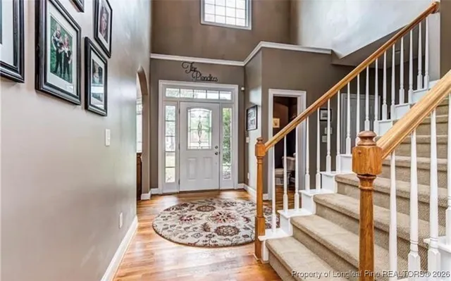 a view of an entryway with wooden floor and livingroom view