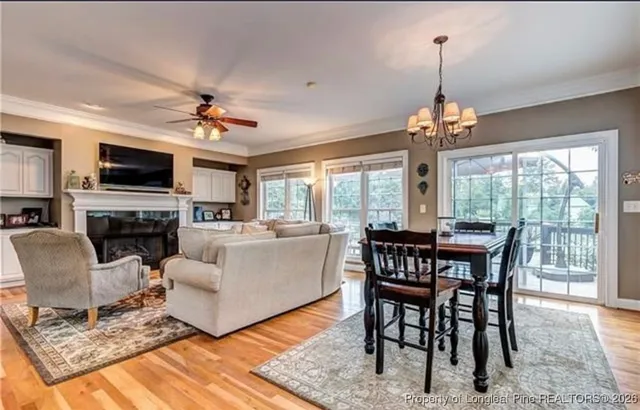 a living room with furniture a chandelier and a fireplace