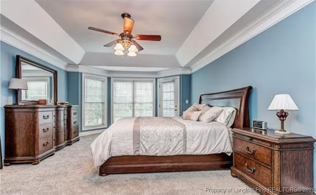 a bedroom with a large bed and a flat tv screen on dresser