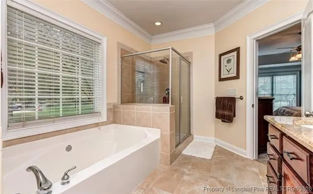 a bathroom with a tub a sink and a large mirror