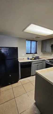 a kitchen with a cabinets and a stove top oven