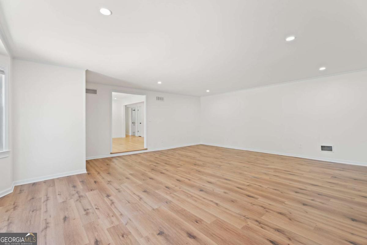 865 Old Tucker Road Stone Mountain, GA 30087 - Photo 13 of 57 a view of empty room with wooden floor