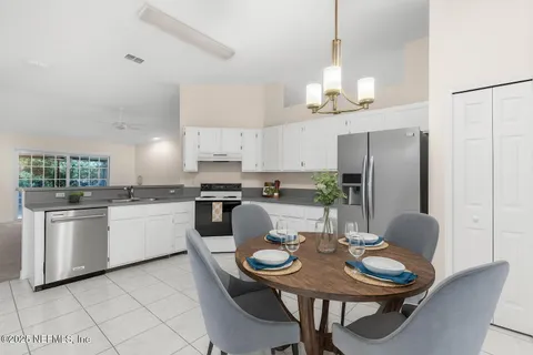 a view of an empty room with a fireplace and a window