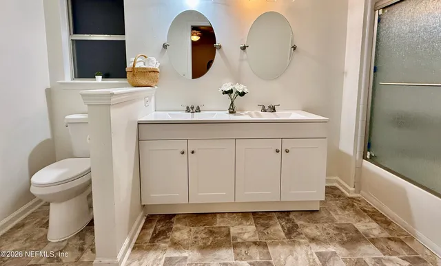 a front view of a house with a garden and plants