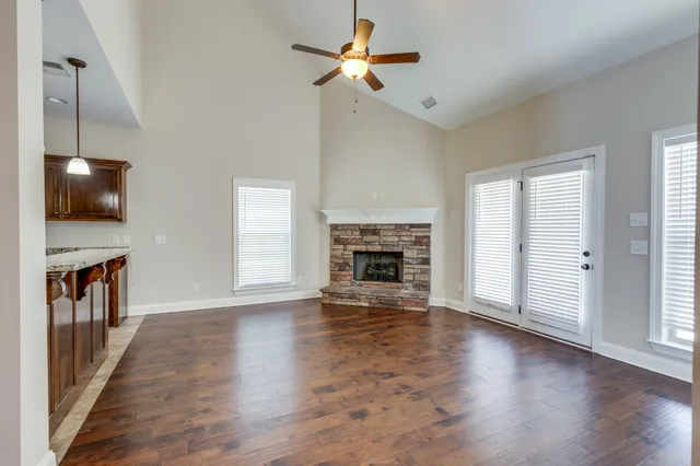 a view of an empty room with window and fireplace