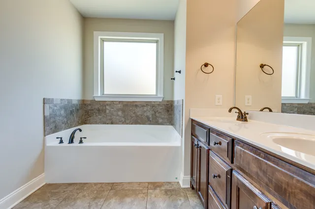 a bathroom with a bathtub and a sink