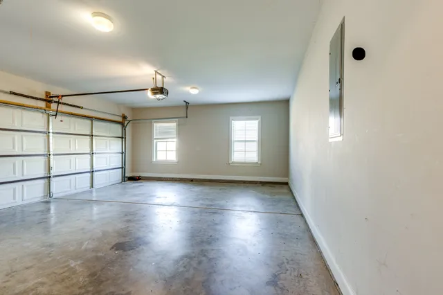 an empty room with windows and closet