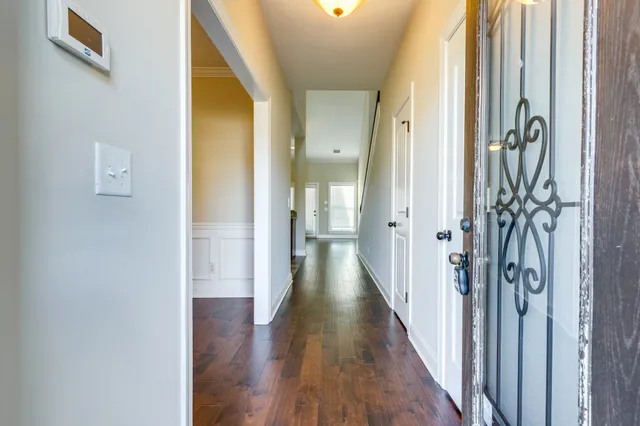 a view of hallway with wooden floor