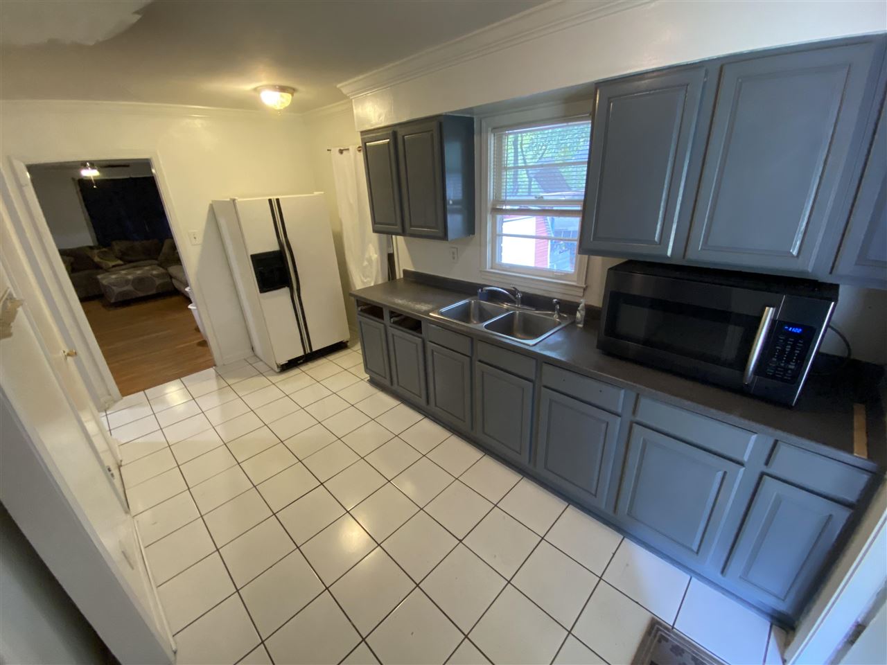 3814 Prescott Road Memphis, TN 38118 - Photo 17 of 22 a kitchen with stainless steel appliances wooden cabinets a stove a microwave and a refrigerator