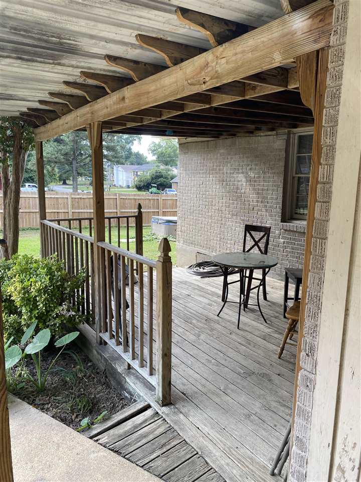 3814 Prescott Road Memphis, TN 38118 - Photo 22 of 22 a view of a patio with table and chairs with wooden floor and fence