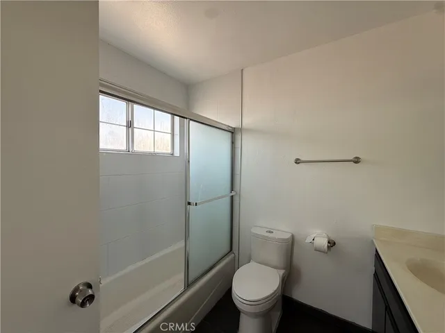 a bathroom with a glass shower door