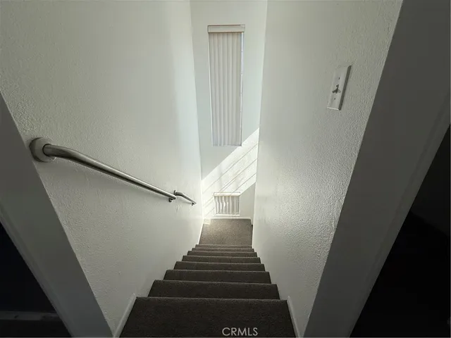 a bathroom with a toilet sink a mirror and window