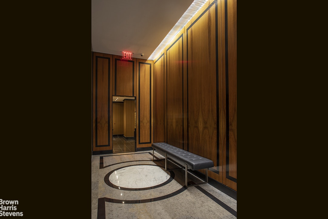 300 East 74th Street, Unit 30AB Manhattan, NY 10021 - Photo 15 of 17 a bathroom with a sink a toilet and a mirror