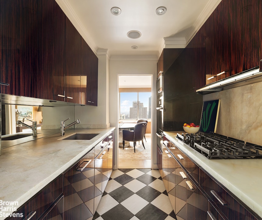 300 East 74th Street, Unit 30AB Manhattan, NY 10021 - Photo 3 of 17 a kitchen with a sink and a stove top oven