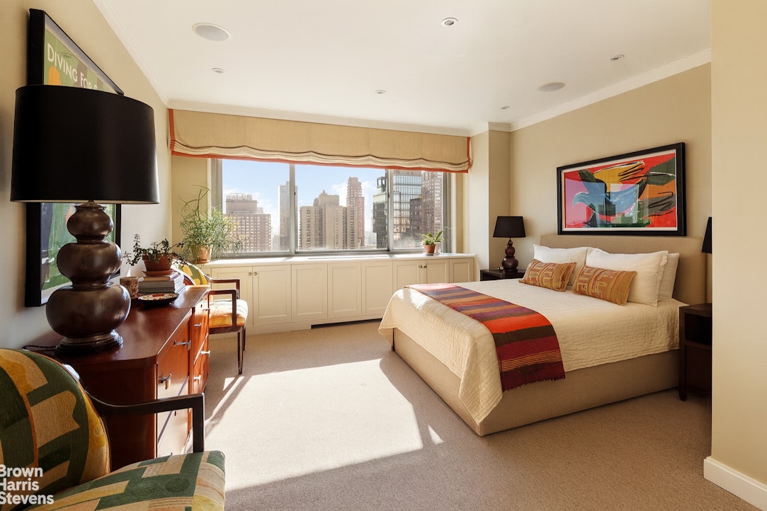 300 East 74th Street, Unit 30AB Manhattan, NY 10021 - Photo 7 of 17 a bedroom with a bed and dresser next to a window