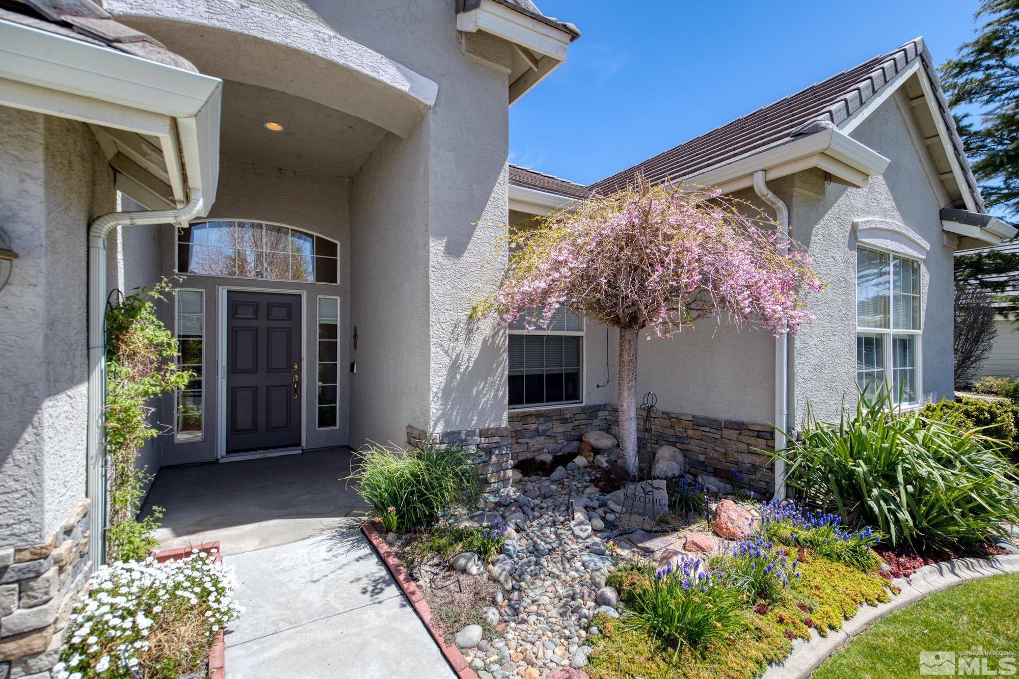 9638 Shadowstone Way Reno, NV 89521 - Photo 1 of 40 a front view of a house with garden