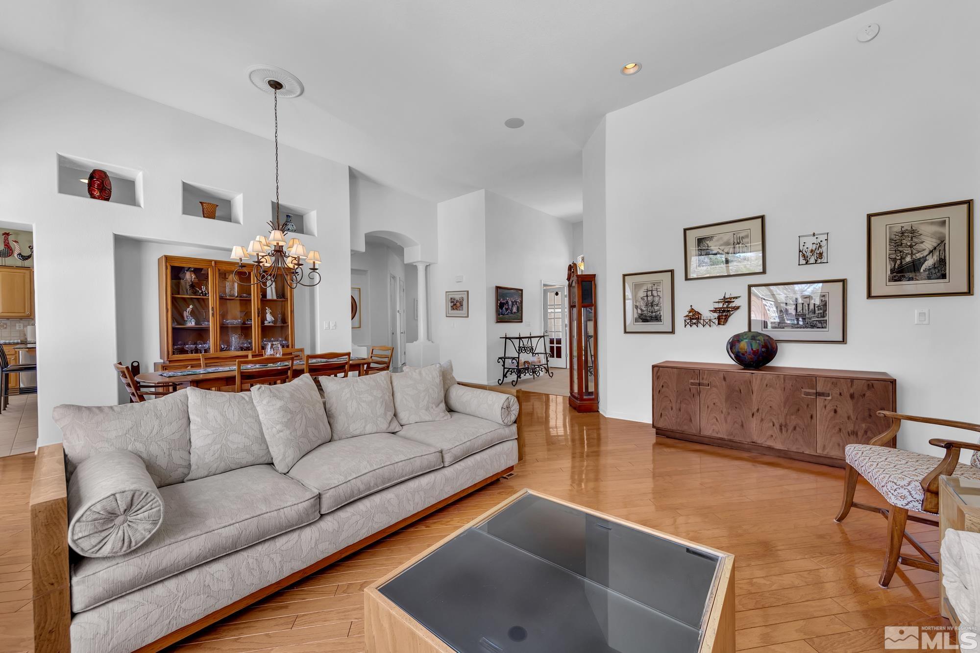 9638 Shadowstone Way Reno, NV 89521 - Photo 12 of 40 a living room with furniture and a chandelier