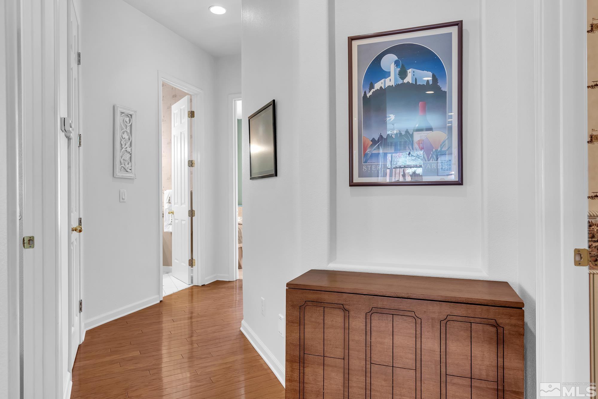 9638 Shadowstone Way Reno, NV 89521 - Photo 19 of 40 a view of a hallway with wooden floor