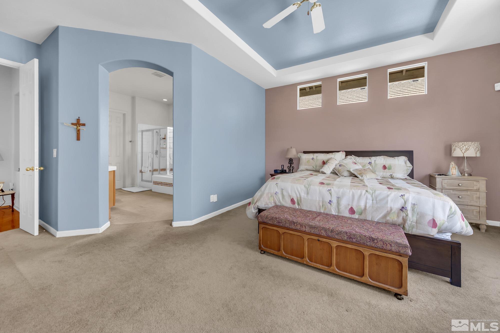 9638 Shadowstone Way Reno, NV 89521 - Photo 20 of 40 a bedroom with a bed and a chandelier