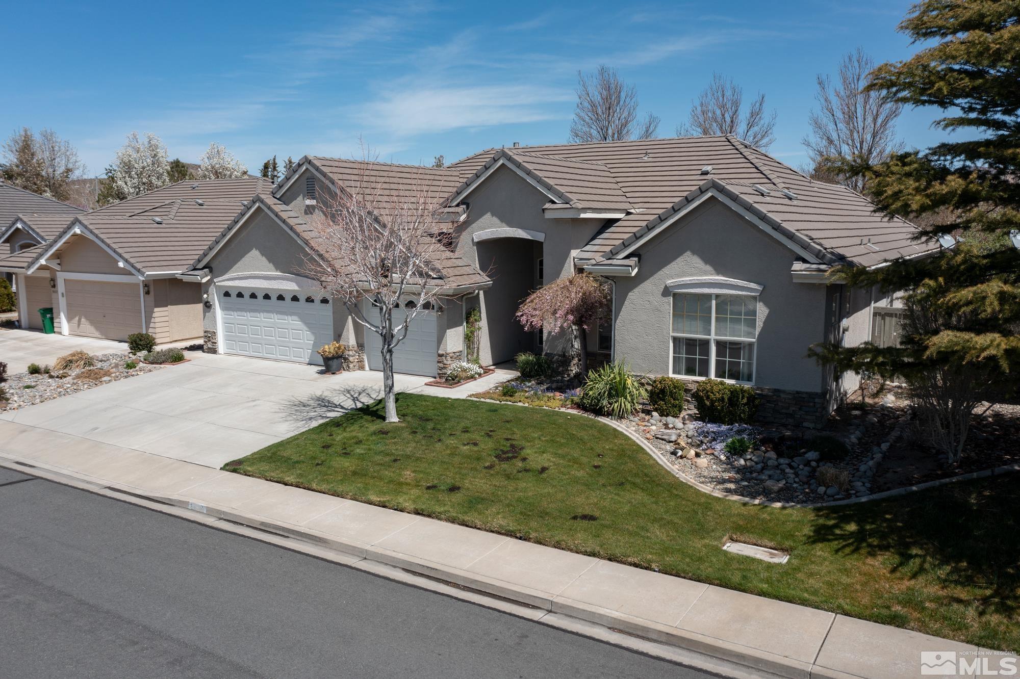 9638 Shadowstone Way Reno, NV 89521 - Photo 2 of 40 a front view of a house with garden