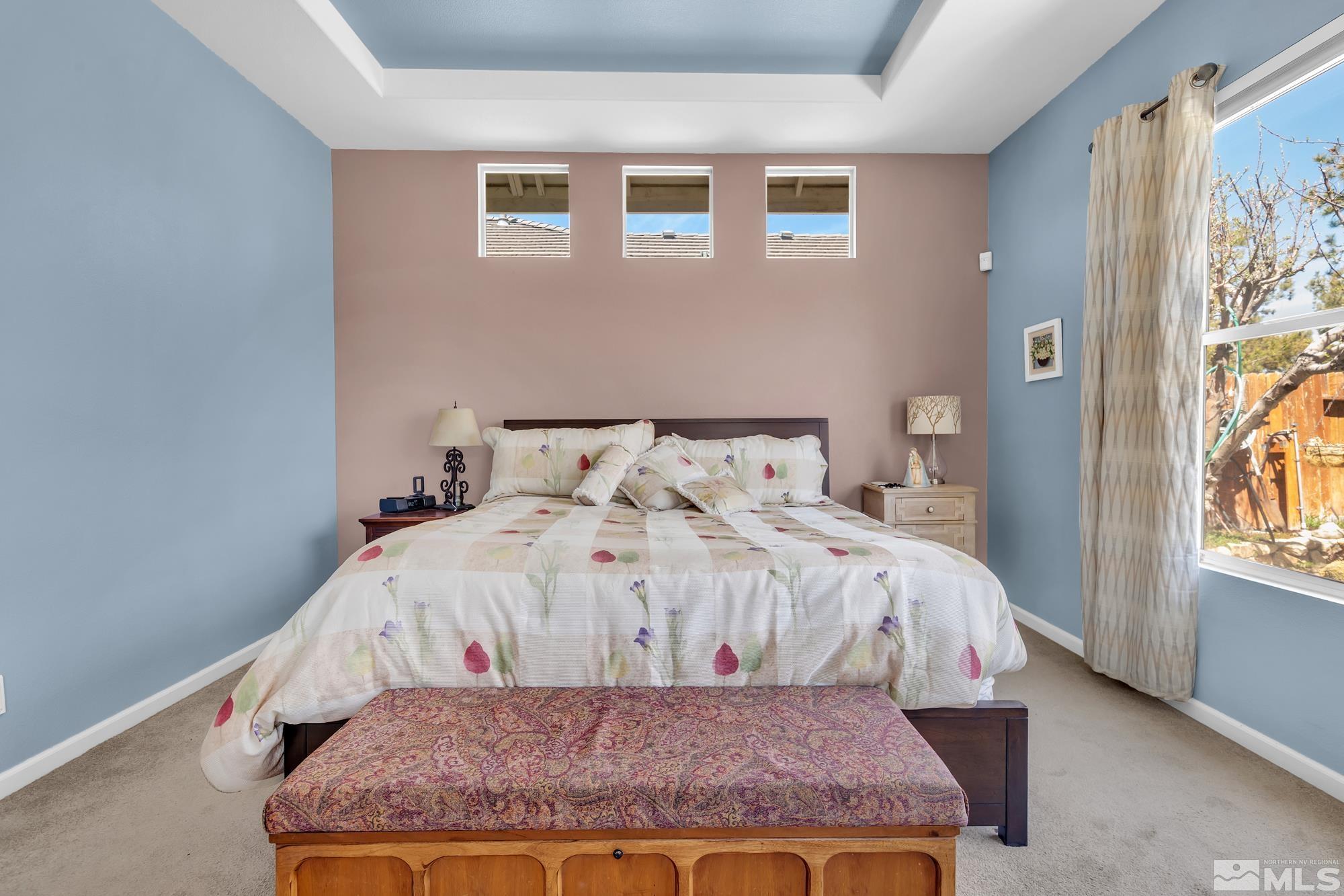 9638 Shadowstone Way Reno, NV 89521 - Photo 21 of 40 a bed sitting in a bedroom next to a window