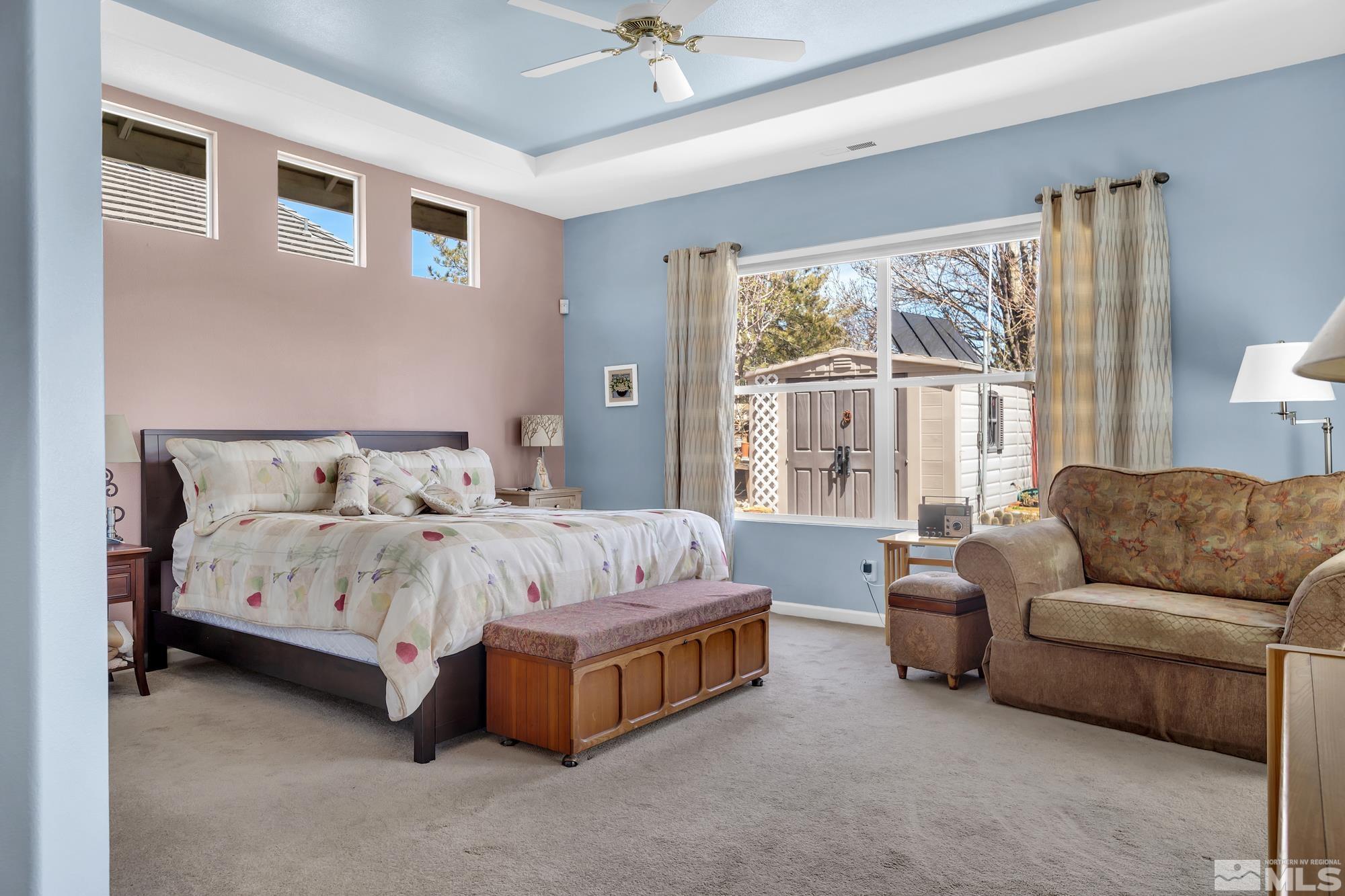 9638 Shadowstone Way Reno, NV 89521 - Photo 22 of 40 a spacious bedroom with a bed and a couch