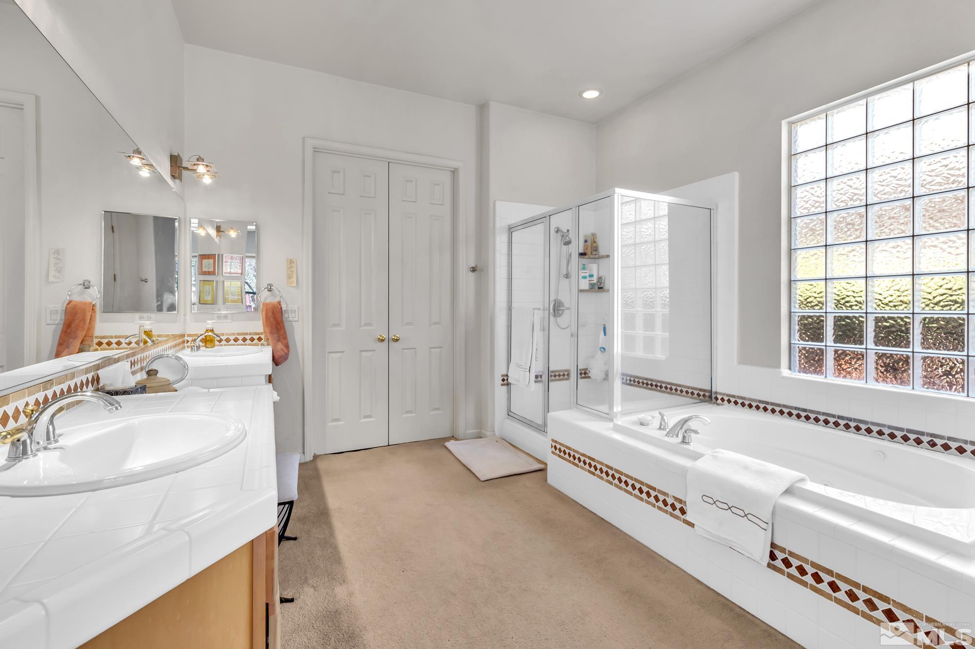 9638 Shadowstone Way Reno, NV 89521 - Photo 23 of 40 a spacious bathroom with a tub sink and mirror