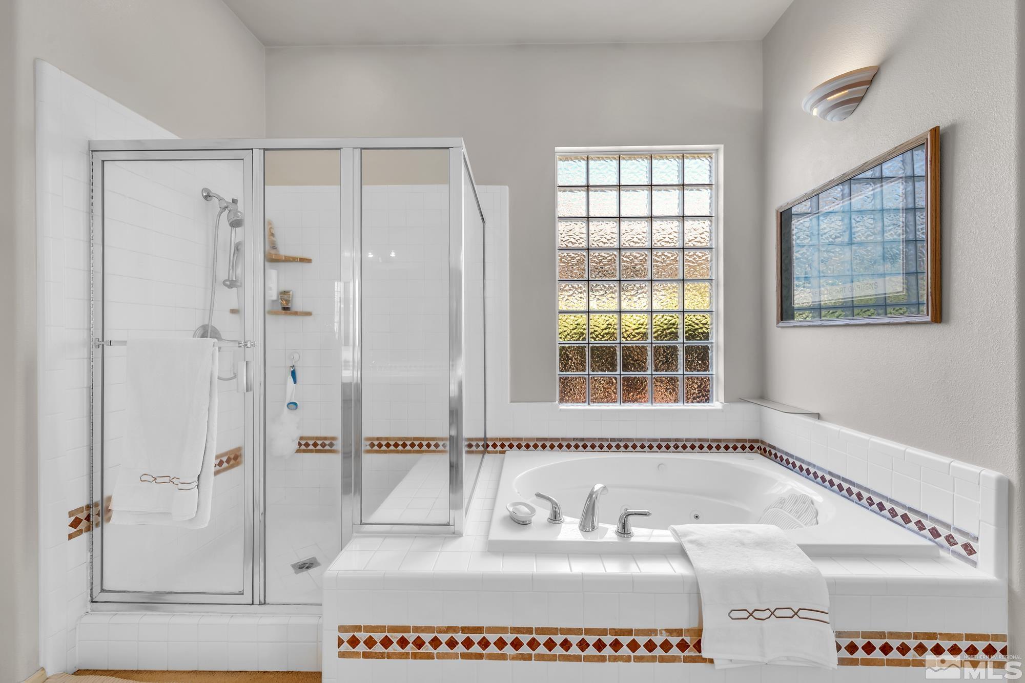 9638 Shadowstone Way Reno, NV 89521 - Photo 24 of 40 a bathroom with a tub sink and a shower