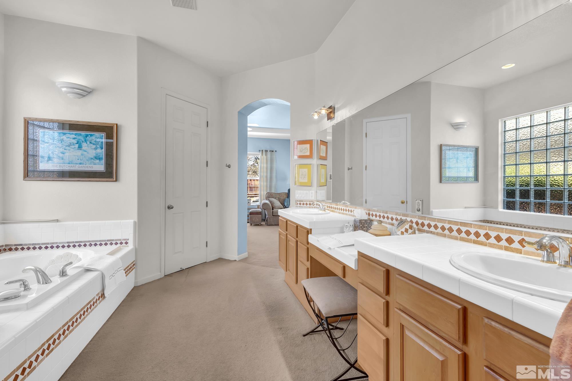 9638 Shadowstone Way Reno, NV 89521 - Photo 25 of 40 a spacious bathroom with a tub a sink and mirror