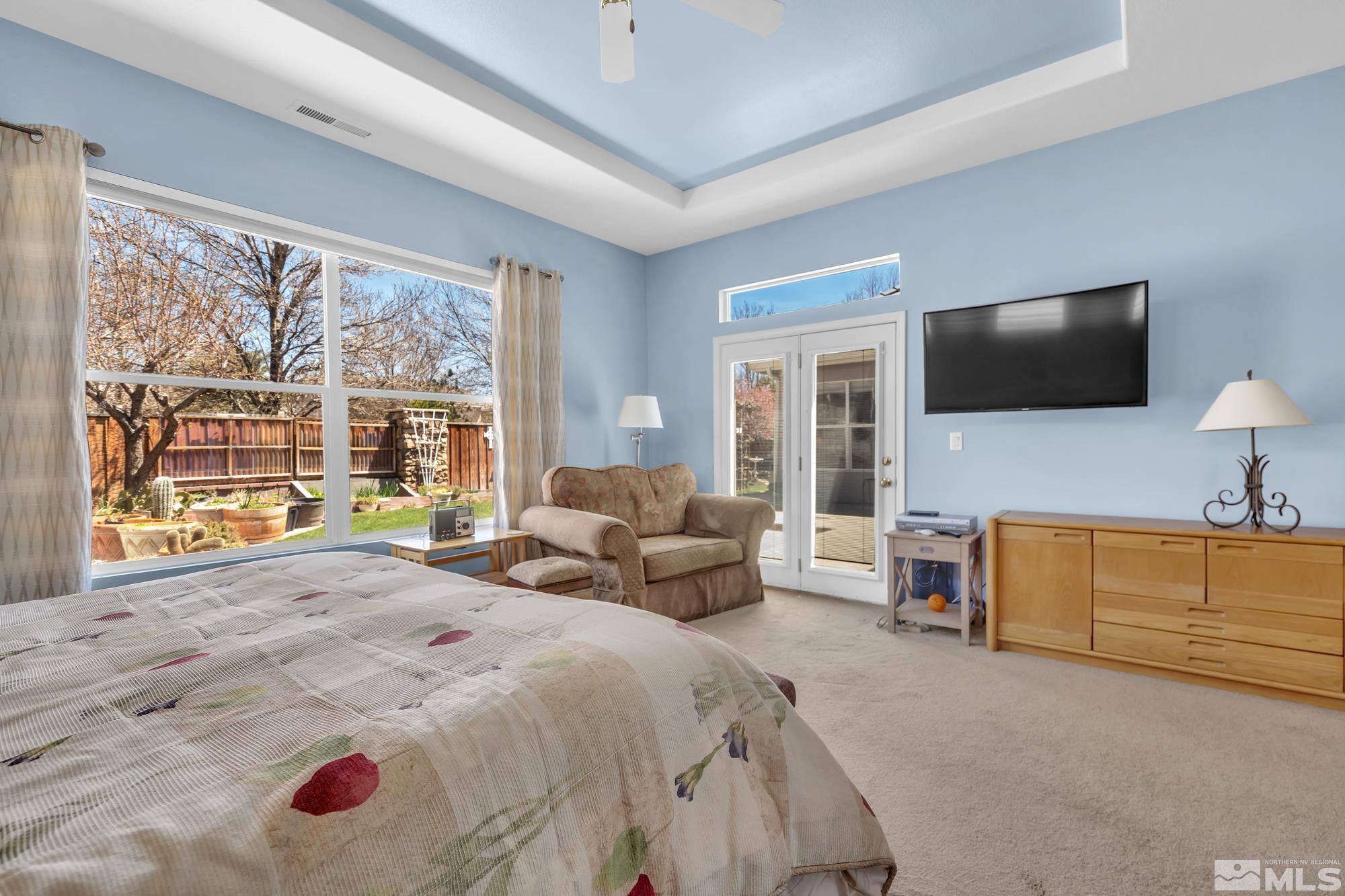 9638 Shadowstone Way Reno, NV 89521 - Photo 26 of 40 a spacious bedroom with a bed and a flat screen television