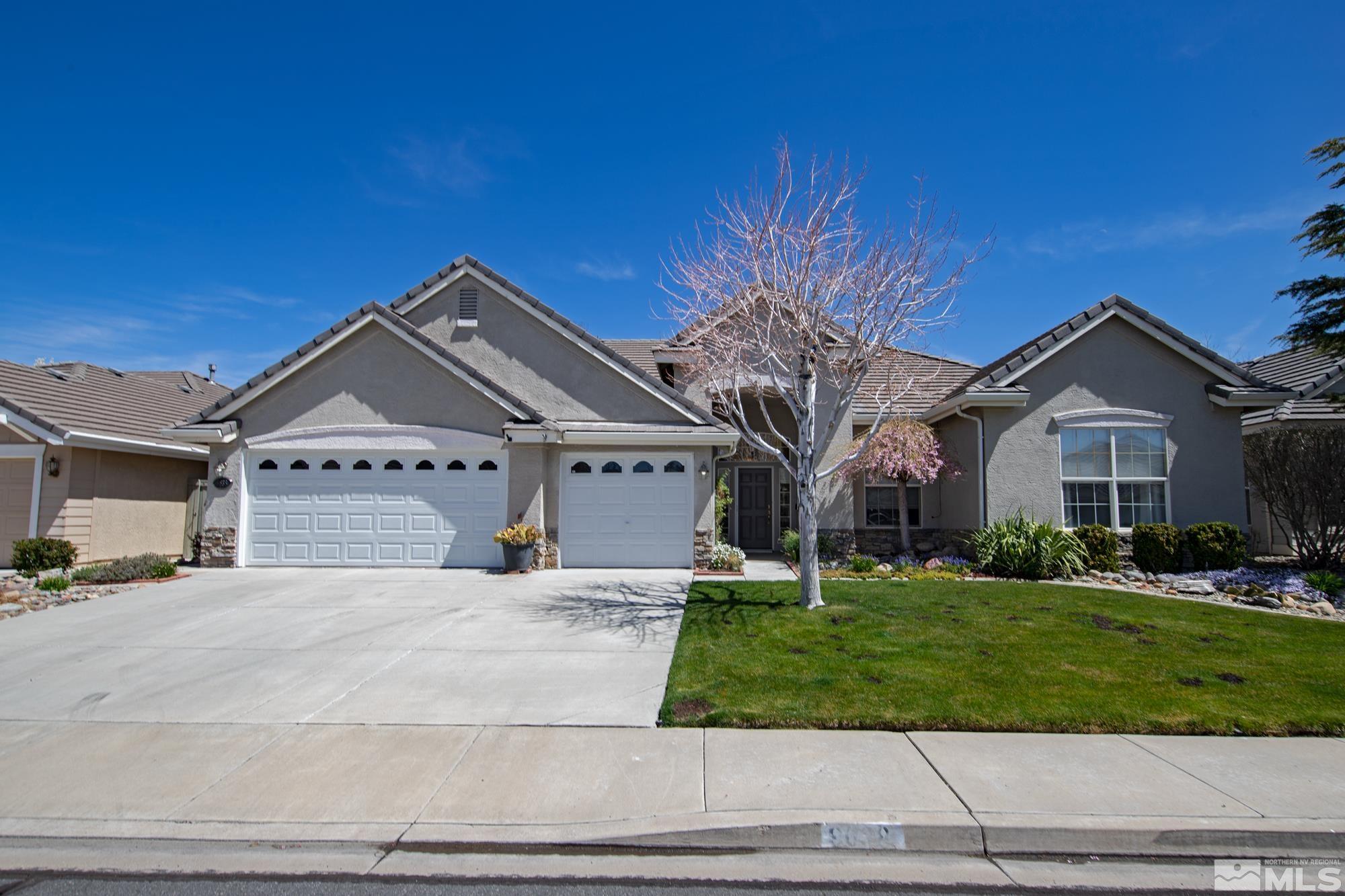 9638 Shadowstone Way Reno, NV 89521 - Photo 3 of 40 a front view of a house with a yard and garage