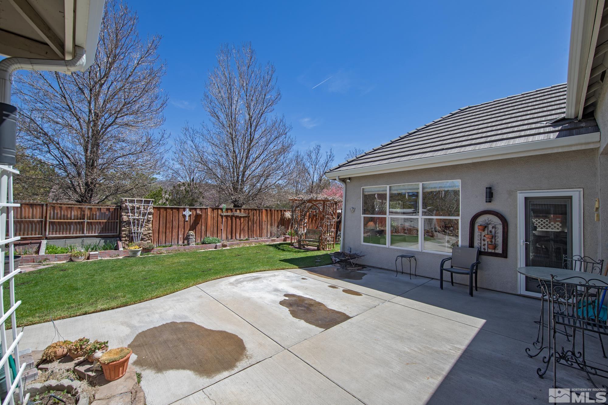 9638 Shadowstone Way Reno, NV 89521 - Photo 35 of 40 a backyard of a house with table and chairs