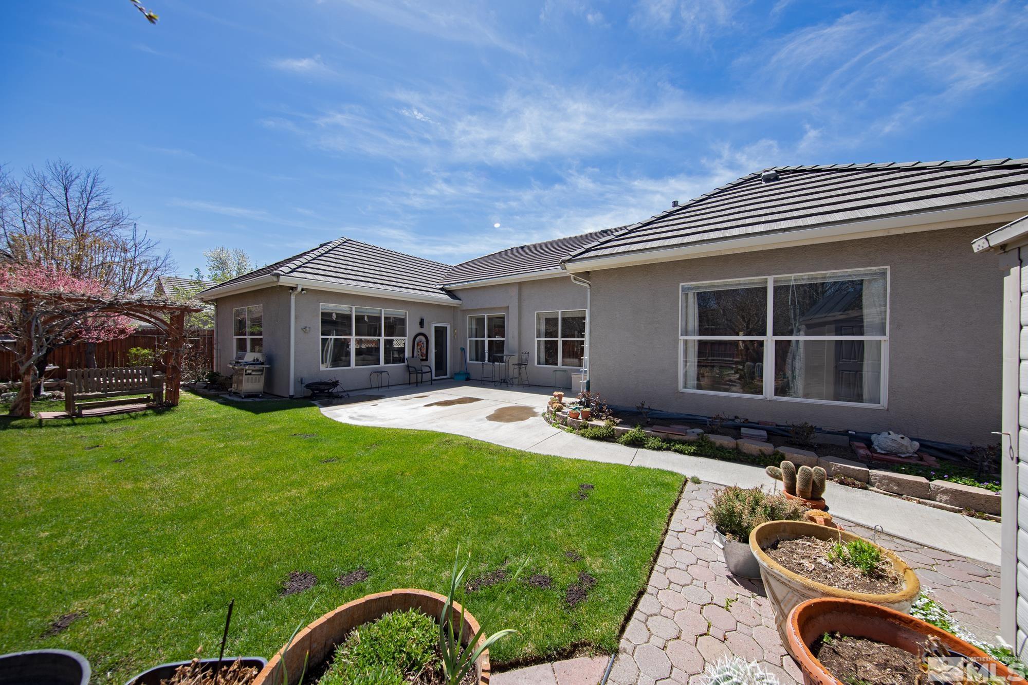 9638 Shadowstone Way Reno, NV 89521 - Photo 36 of 40 a front view of a house with a yard table and chairs