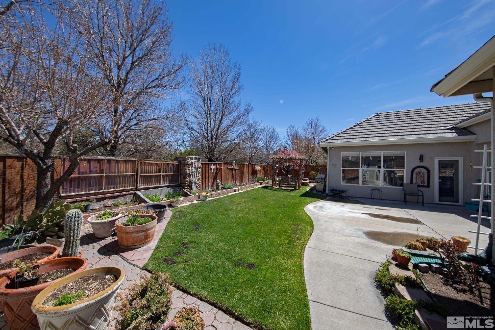 9638 Shadowstone Way Reno, NV 89521 - Photo 37 of 40 a front view of a house with garden and porch