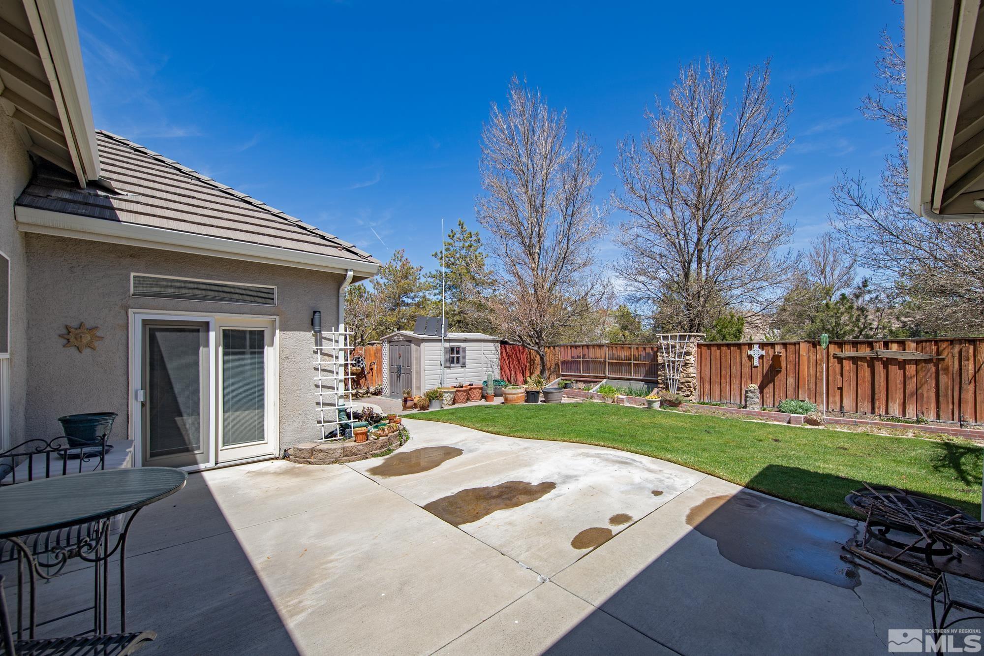 9638 Shadowstone Way Reno, NV 89521 - Photo 38 of 40 a view of a backyard with table and chairs with wooden fence