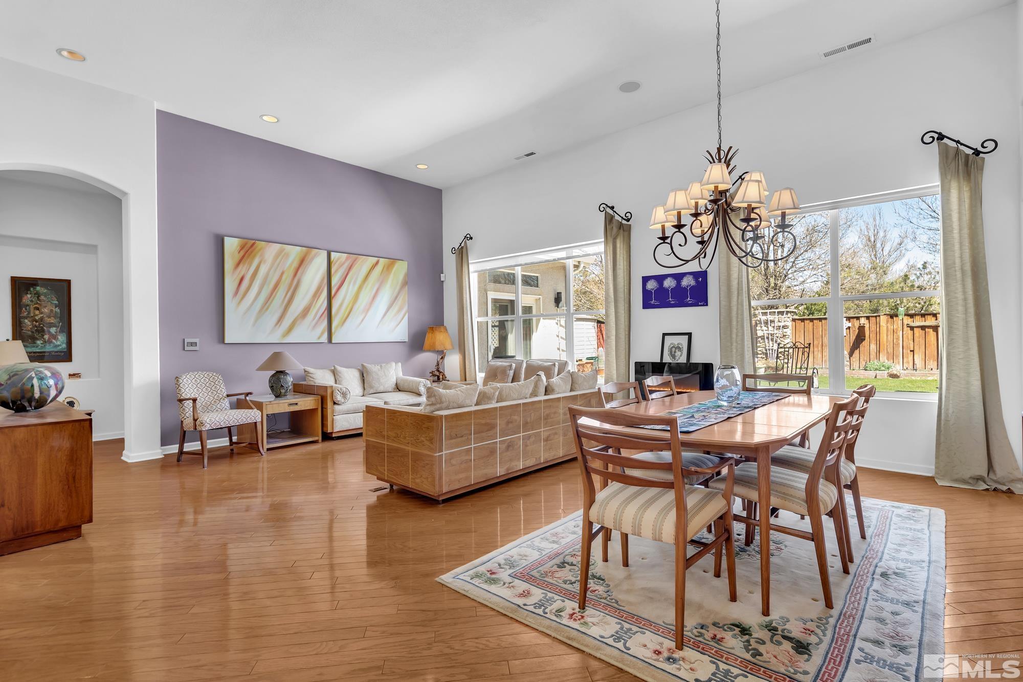 9638 Shadowstone Way Reno, NV 89521 - Photo 7 of 40 a living room with fireplace furniture and a chandelier