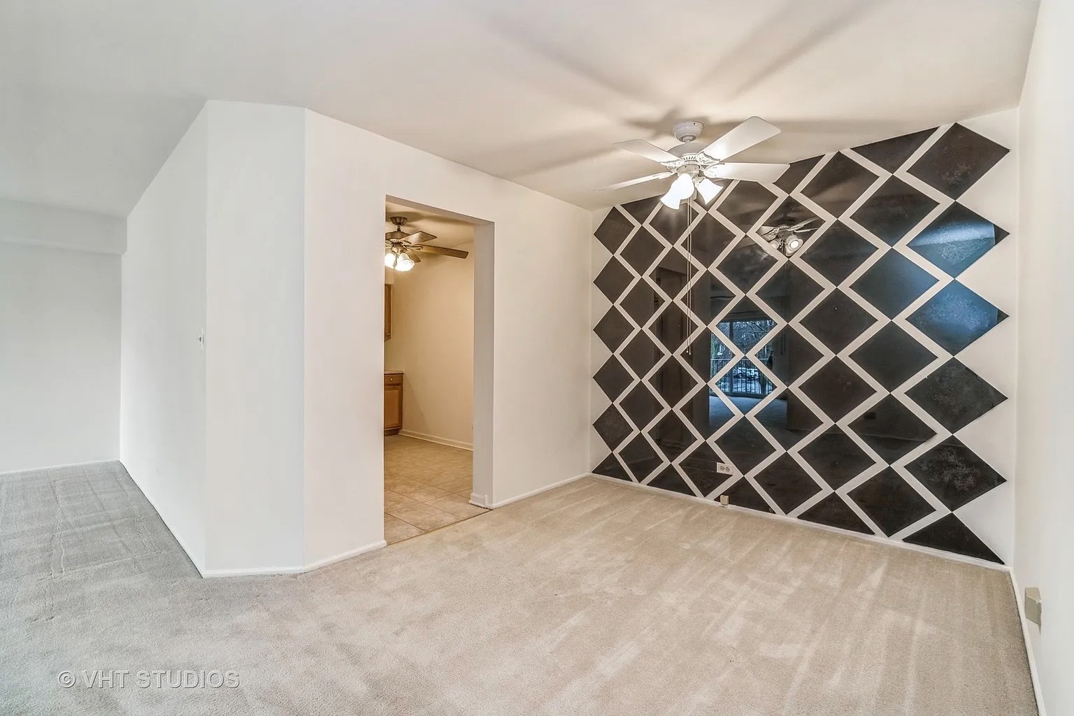 1450 Sandpebble Drive, Unit 227 Wheeling, IL 60090 - Photo 3 of 11 an empty room with wooden wall and a large window