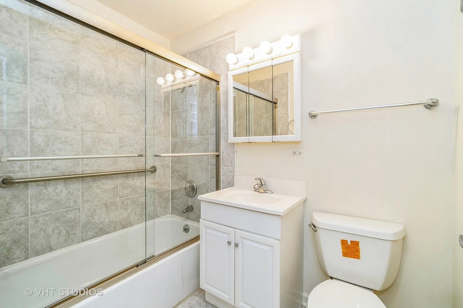 1450 Sandpebble Drive, Unit 227 Wheeling, IL 60090 - Photo 7 of 11 a bathroom with a sink a toilet and shower