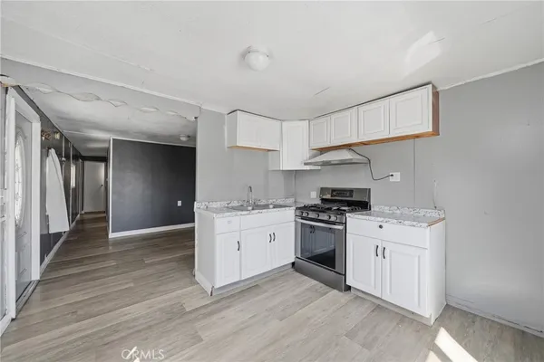 a kitchen with stainless steel appliances granite countertop a stove and a sink