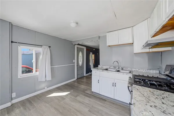 a kitchen with stainless steel appliances a sink stove and cabinets